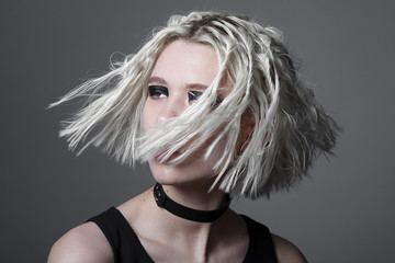 Studio beauty portrait of young woman with black graphic makeup.