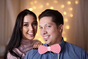 Funny couple playing with fake bowtie