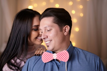 Funny couple playing with fake bowtie