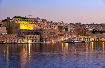 Fototapeta na wymiar The early morning view of Valletta fortifications from the water