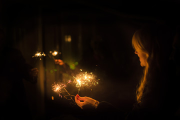 burning sparkler in a woman hand 