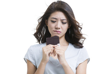 Young woman eating chocolate