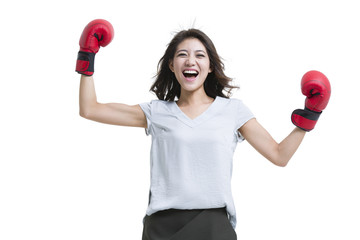 Happy young woman wearing boxing gloves