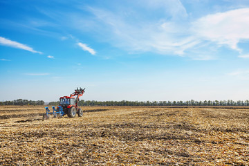 Farmer works in field on a tractor