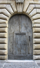 Italian architecture detail. Old medieval style front door in Florence, Italy