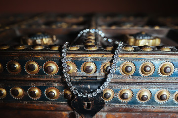bride necklace on an antique trunk