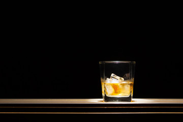 whiskey on the rock on black background