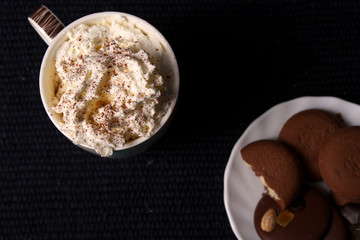 Milk and cream in the cup with chocolate and cookies. top view 