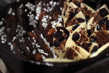 White and dark chocolate candy with nuts and raisins