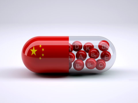 Pill with Chinese flag wrapped around it and red ball inside