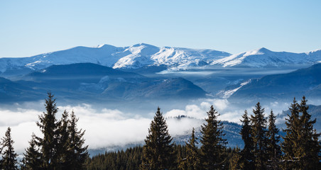 Winter mountains covered with fog