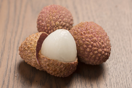 Lychees on wooden background