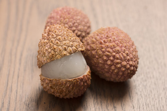 Lychees on wooden background