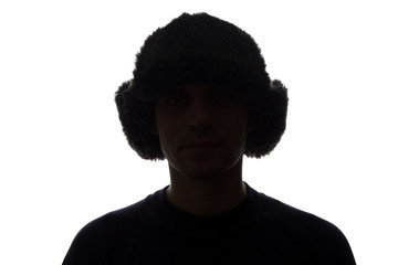 Young man in hat look ahead - horizontal silhouette