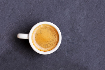 White cup of espresso coffee on background