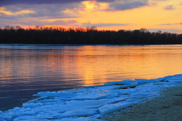Bright sunset over the river Dnieper on winter