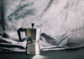 Geyser coffee maker and cup of black coffee on the wooden table