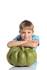 Fototapeta premium Cute boy sitting with pumpkin