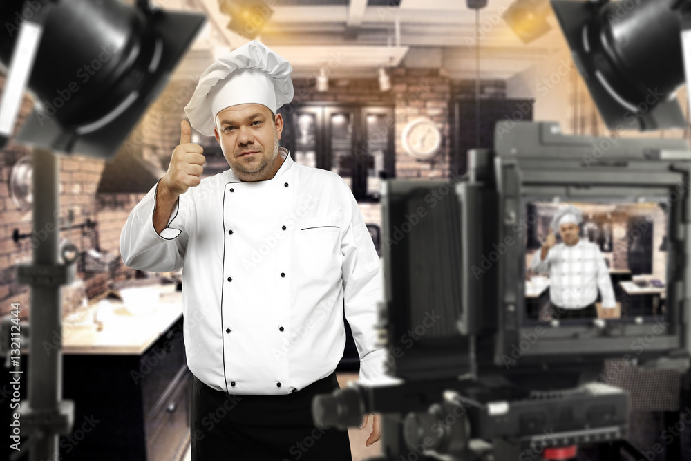 Wall mural cook chef in tv studio 