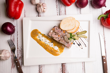 aspic on a plate with mustard