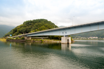 Fototapeta na wymiar Kawaguchiko lake and the bridge in autumn, Yamanashi, Japan