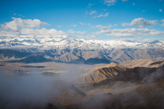 Aerial view of Le-h City, landscape with ice peaks , blue sky in background , Ladak-h, Jam-mu and Kashmir, India