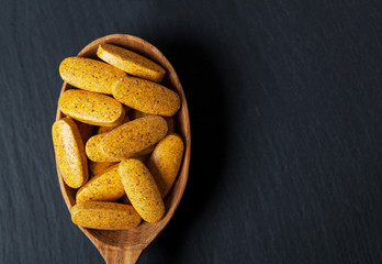 dietary supplement. multivitamin tablets on black background