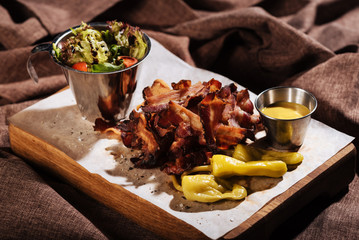 Close up of bacon and vegetables standing on a tray