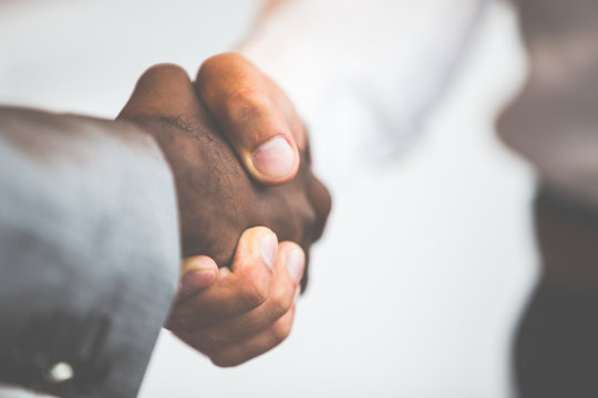Handshake between african and a caucasian man