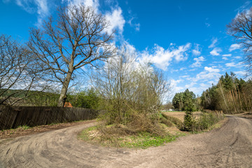 Crossroads in countryside landscape in spring