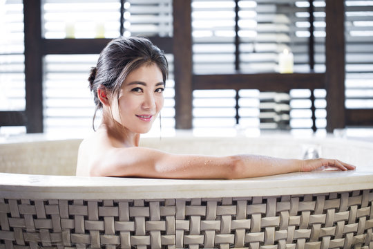 Beautiful young woman in bathtub
