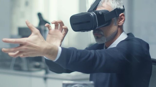 IT Engineer Working with Virtual Reality Headset On. He Works in His Modern and Minimalistic Office.  Shot on RED Cinema Camera in 4K (UHD). 