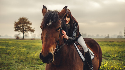 Fototapeta premium Beautiful girl riding a horse