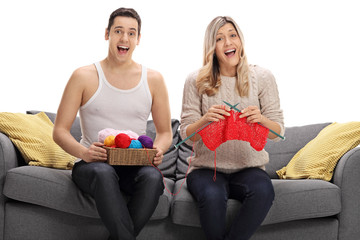 Overjoyed couple knitting together