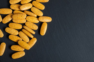 Alternative medicine tablets on a black background