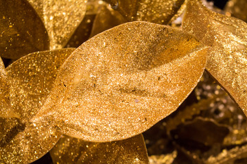 Golden background with Christmas decorative leaf. 