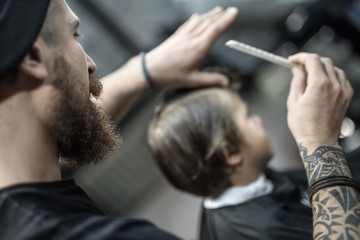 Barber and his client in barbershop