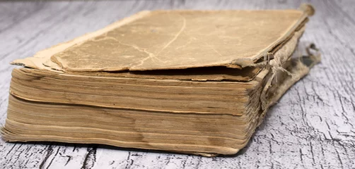 closedold book on a wooden background © Надежда Романовская