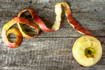 Whole apple with peeled peel on wooden table from above, copy sp © alicja neumiler