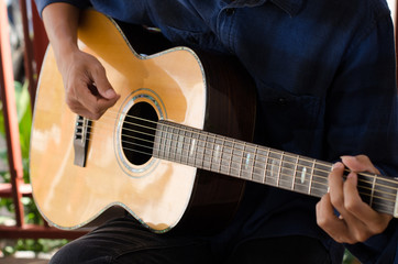 Fototapeta na wymiar .A young man playing acoustic guitar happy and relaxed in the da