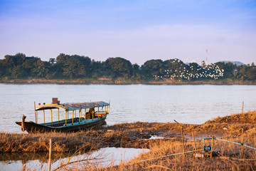 Fototapeta na wymiar long-tailed boat on river at countryside Chiang Kan Thailand.