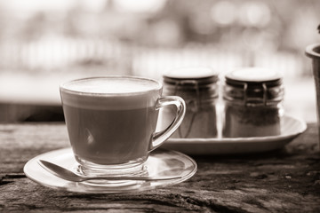 Hot coffee on old wood table black and white tone.