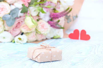 Valentine's Day. Valentine Gift. Red Hearts and bouquet of flowers on blue wooden background. Beautiful Valentine card art design