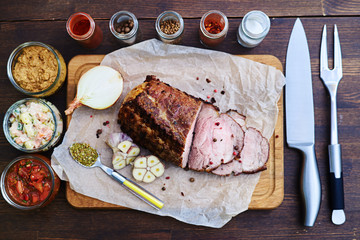 Composition of seasoned meat, spices, cutlery accompanied with s