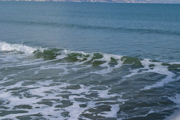 Snowy beach and sea at winter with blue sky