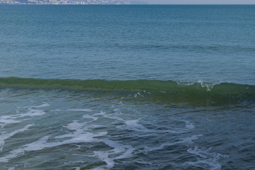 Snowy beach and sea at winter with blue sky