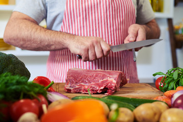Crop shot of hands sharpening knife for cutting meat