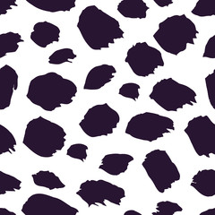 Seamless abstract pattern with brushstrokes and splatters painted in black and white