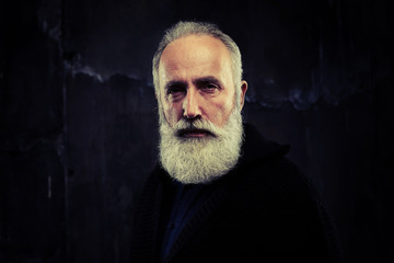 Elderly man with smart beard looking wisely