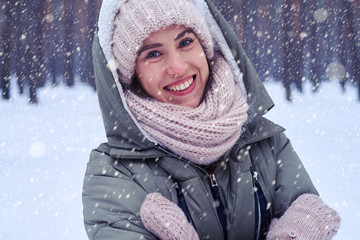 Funny female with folded hands looking at the camera in the fore